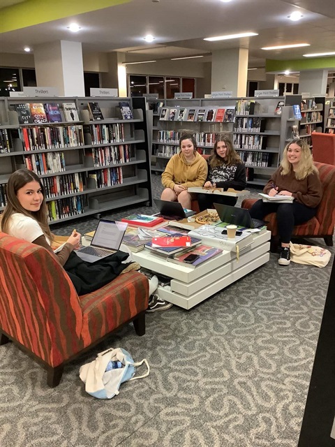 4 stdents sitting in low chairs at Taree Library.jpg